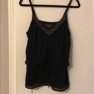 Black sleeveless blouse with gold studs
